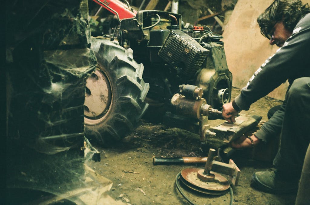 A Mechanic in a Sweater Fixing an Engine